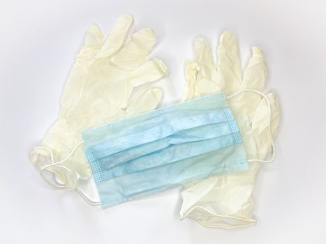 Antibacterial medical mask of blue color and gloves on a white background virus epidemic corona virus protection