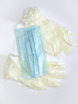 Antibacterial medical mask of blue color and gloves on a white background virus epidemic corona virus protection