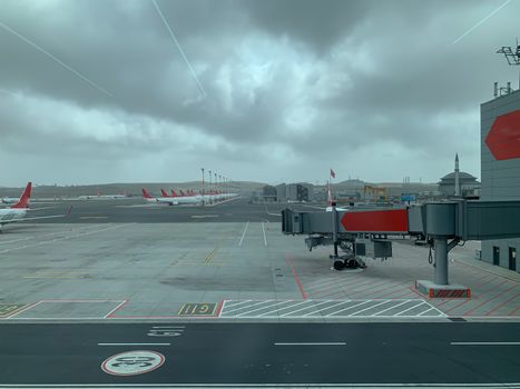 Empty Istanbul airport with parked planes, no people and flights during covid-19 coronavirus pandemic epidemy in the world quarantine. Horizontal stock image.