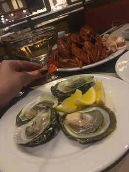 Oysters lobster crayfish craw fish seafood and champagne on table in restaurant 