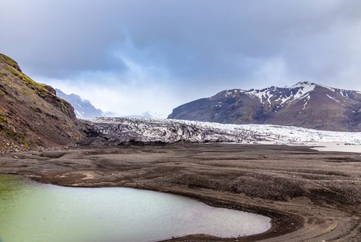 Skaftafellsjokull glacier with mountains and green lake in front, Vatnajokul national park, South Iceland