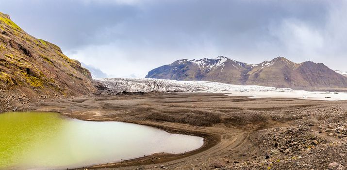 Skaftafellsjokull glacier with mountains and green lake in front, Vatnajokul national park, South Iceland
