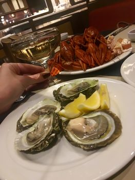 Oysters lobster crayfish craw fish seafood and champagne on table in restaurant 