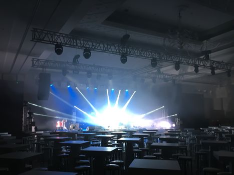 Rehearsal in big concert hall with a performance stage with led screen, sound and light systems. Horizontal image