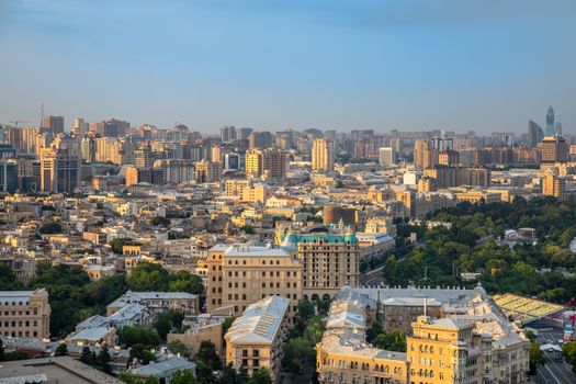 Overview panorama of central city business district and residential suburbs in sunset rays, Baku, Azerbaijan