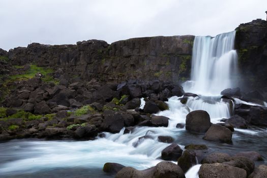 Oxararfoss waterfall streams falling from the mountain, Tingvellir National Park, Iceland