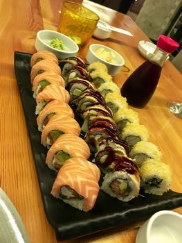 Delicious sushi and rolls on a table in a restaurant