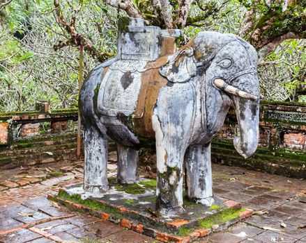 Elephant combat old stone statue