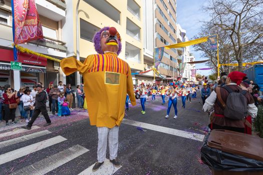Loule, Portugal - February 25, 2020: Man disguised as a giant in the street in front of the public in the parade of the traditional carnival of Loule city on a February day