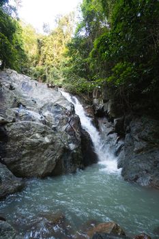 Secret tropical waterfall in jungle on a Samui island