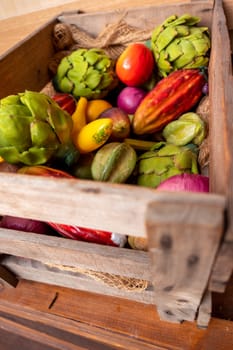 A wooden box decorated with various vegetables and fruits made of plastic or plastic, including mango, star fruit artichoke and banana in bright colors.