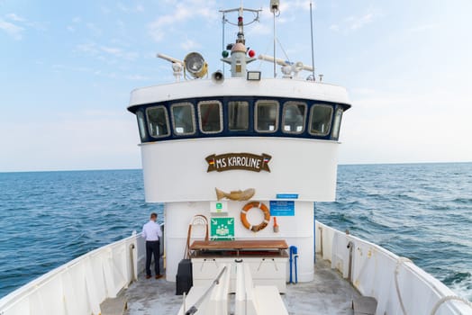 Fehmarn, Schleswig-Holstein/Germany - 03.09.2019: An old white steel boat for trips and fishing trips on the Baltic Sea with technical equipment and the bridge