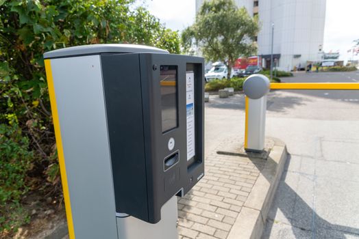 Fehmarn, Schleswig-Holstein/Germany - 05.09.2019: A yellow barrier with associated parking ticket machine for opening to a private parking lot of a hotel.