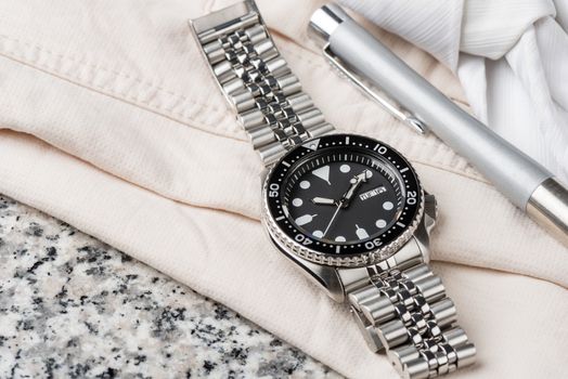 Close up men dive watch with stainless steel bracelet, luxury wristwatch for men.