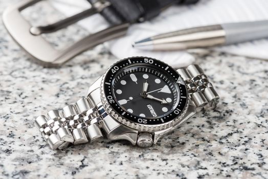 Close up men dive watch with stainless steel bracelet, luxury wristwatch for men.