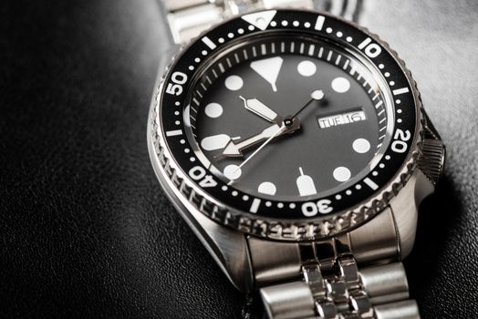 Close up men dive watch with stainless steel bracelet, luxury wristwatch for men.