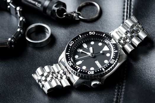 Close up men dive watch with stainless steel bracelet, luxury wristwatch for men.