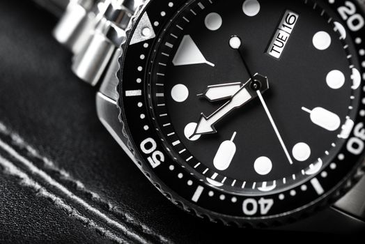 Close up men dive watch with stainless steel bracelet, luxury wristwatch for men.