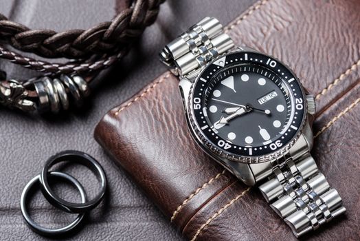 Close up men dive watch with stainless steel bracelet, luxury wristwatch for men.