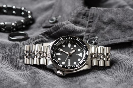 Close up men dive watch with stainless steel bracelet, luxury wristwatch for men.