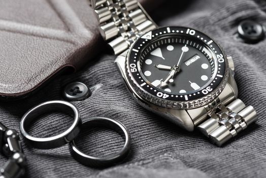 Close up men dive watch with stainless steel bracelet, luxury wristwatch for men.