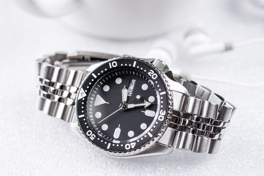 Close up men dive watch with stainless steel bracelet, luxury wristwatch for men.