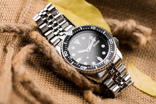 Close up men dive watch with stainless steel bracelet, luxury wristwatch for men.