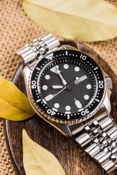 Close up men dive watch with stainless steel bracelet, luxury wristwatch for men.