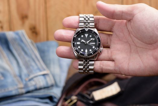 Close up men dive watch with stainless steel bracelet, luxury wristwatch for men.