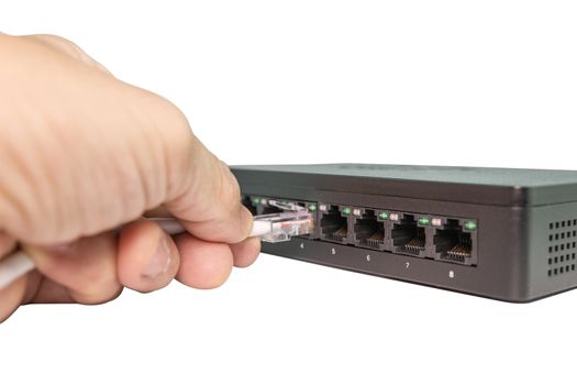 Hand of man holding The blue network cables connect port switch on white table concept internet network connection, clipping path