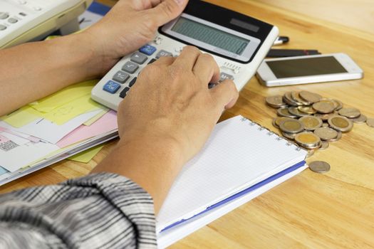 businessman use a calculator to calculate income and expenses in the office concepts, accounting, finance, investment