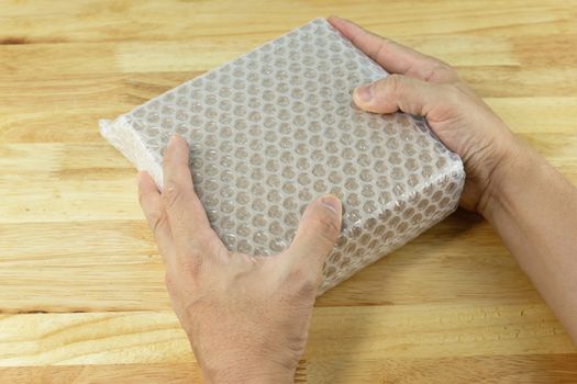 hand of man hold bubble wrap, for protection parcel product cracked or insurance During transit  