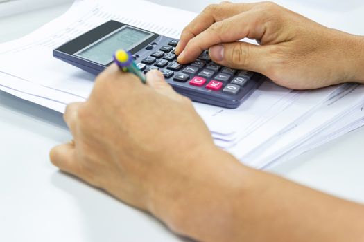 Employees use office calculators with documents of income, expenses, concept of life at work.