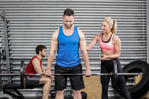 Fit people doing exercises at gym