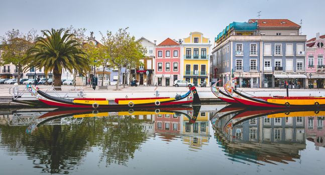 Aveiro, Portugal - May 7, 2018: Tourists walk on famous Moliceiros on a spring evening, traditional boats used to harvest seaweeds in the past