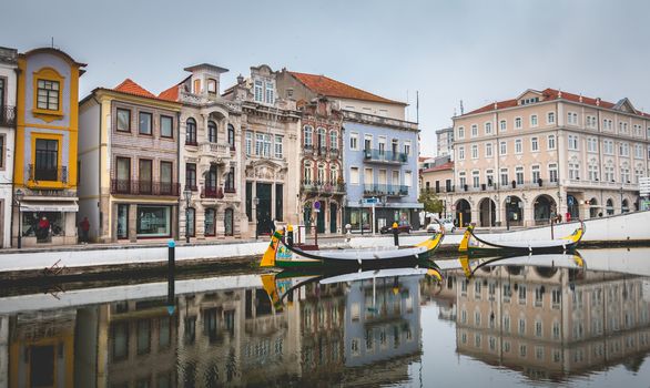 Aveiro, Portugal - May 7, 2018: Tourists walk on famous Moliceiros on a spring evening, traditional boats used to harvest seaweeds in the past