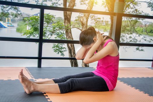 Asian women wearing pink shirts Exercise by stretching the body.