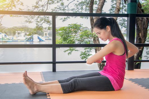 Asian women wearing pink shirts Exercise by stretching the body.