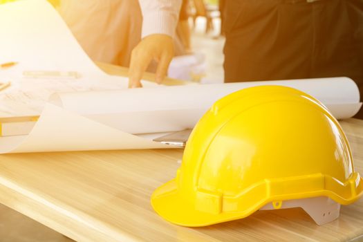 A group of engineers are looking at a blueprint for construction on the table. Engineering concept.
