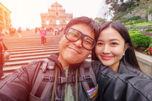 		Young Couple Tourists in Ruins of St.Paul’s,Macau
