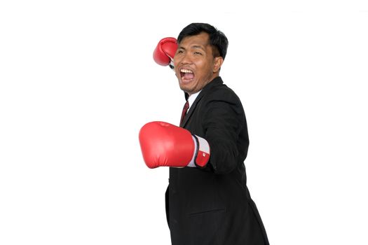 Young businessman wearing boxing gloves It shows that it is ready to fight the competition and problems in the future. Business Boxing concept.