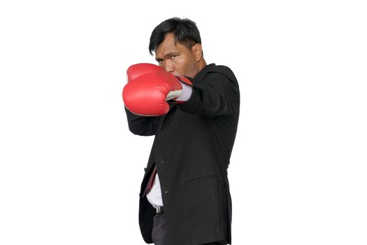 Young businessman wearing boxing gloves It shows that it is ready to fight the competition and problems in the future. Business Boxing concept.
