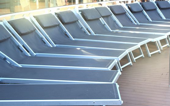 Empty deck chairs on the upper deck of a cruise ship, NOBODY, OUTDOOR, SEA RECREATION CONCEPT.