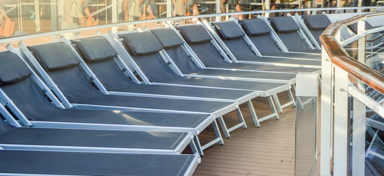 Empty deck chairs on the upper deck of a cruise ship, NOBODY, OUTDOOR, SEA RECREATION CONCEPT.