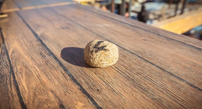 figure 4 written in felt on a small stone on the table of a restaurant