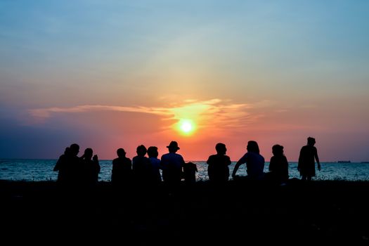 silhouette people family and pet meeting at beach and sea sand sunset background