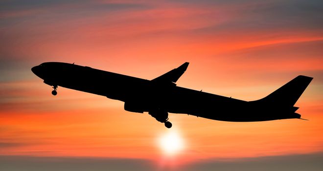 Airplane taking off after from the airport at sunset background, Silhouette of big passenger or cargo aircraft, airline, Business transportation banner or flyer for travel and vacation design concept.