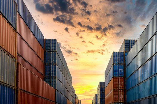 Industrial container yard for business commercial trade logistic transportation oversea worldwide Import Export, Stack of colorful cargo freight ship container at sunset background.