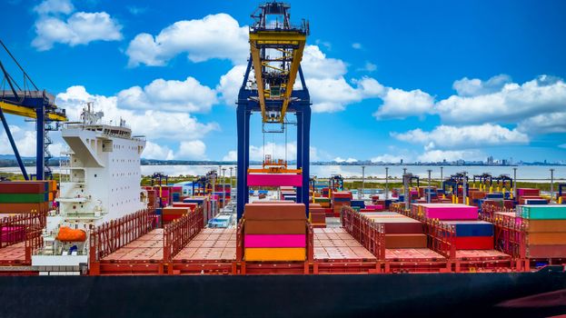 Quay crane, Crane of container terminal in industrial sea port, Sea cargo port with container ship and crane with blue sky background, Business logistic import export transportation by cargo vessel.