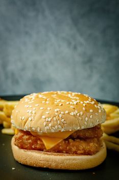 The double burger fish on black plate for food content.